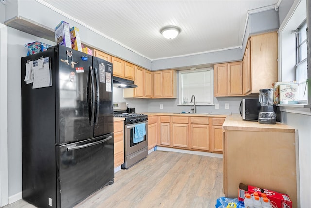 kitchen with sink, crown molding, black refrigerator, stainless steel range with gas cooktop, and light brown cabinets