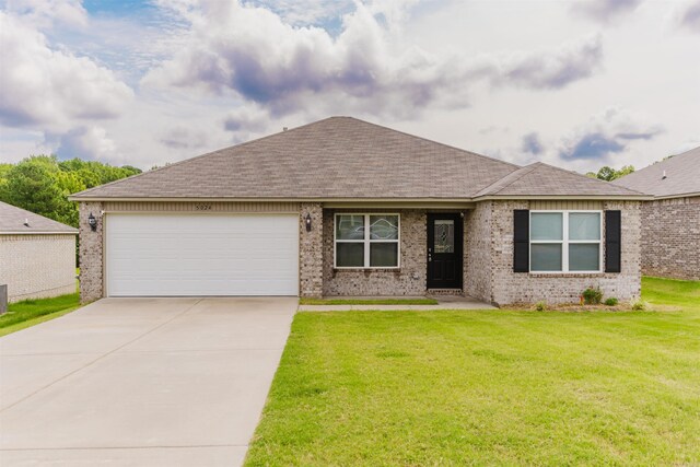 single story home with a garage and a front lawn