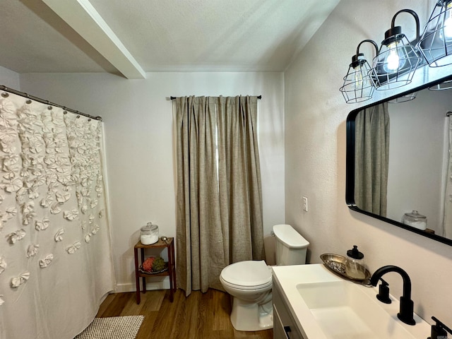 bathroom with vanity, toilet, and hardwood / wood-style floors