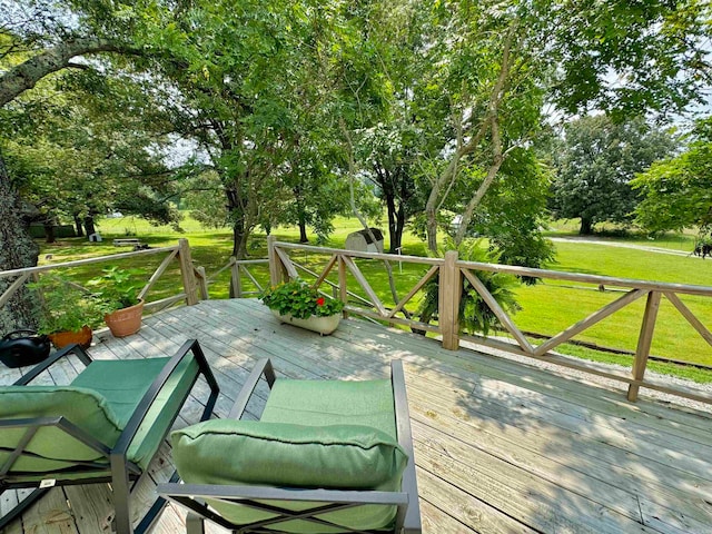 wooden terrace with a yard