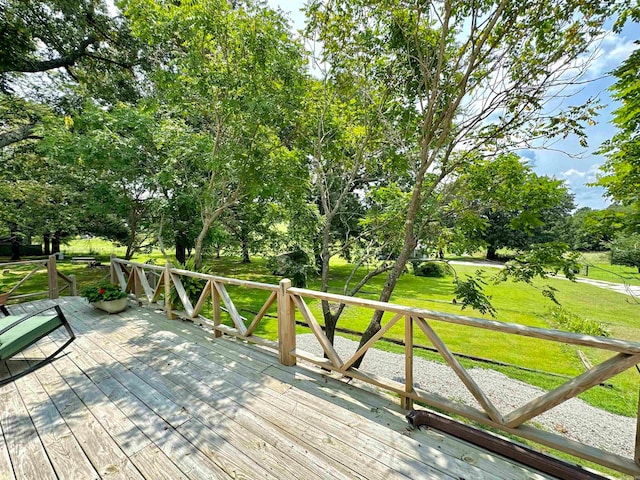 wooden terrace with a lawn