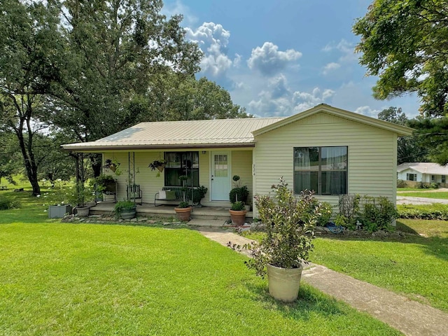 view of front of house with a porch and a front yard