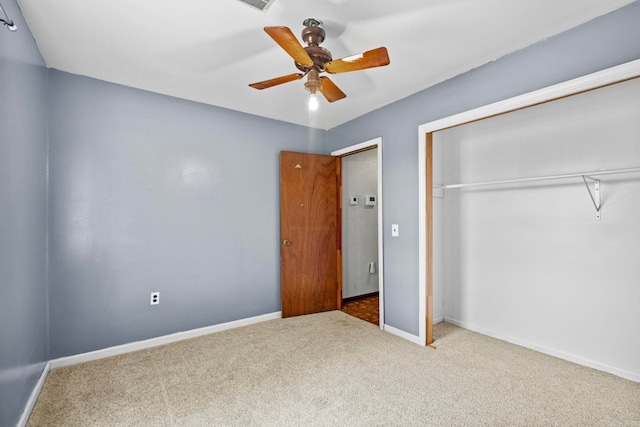 unfurnished bedroom featuring carpet floors, ceiling fan, and a closet