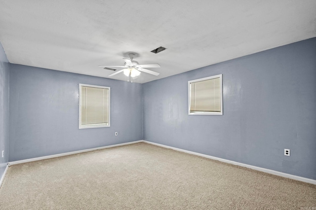 spare room with carpet flooring and ceiling fan