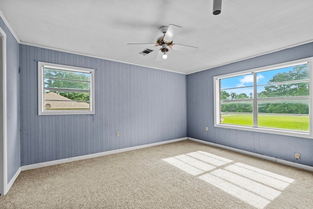 carpeted spare room with ornamental molding and ceiling fan