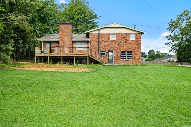 rear view of property with a lawn and a wooden deck