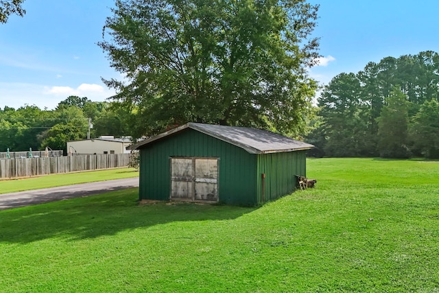 view of outbuilding with a yard