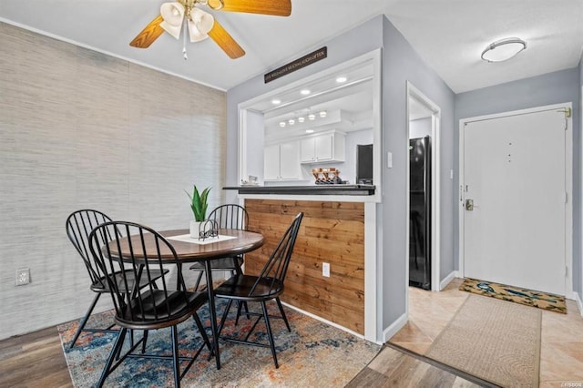 dining room featuring light hardwood / wood-style floors and ceiling fan