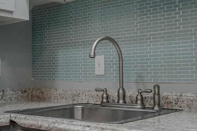 kitchen featuring light stone countertops and sink