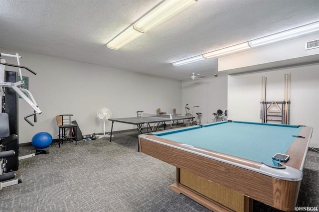 game room featuring billiards, carpet, and a textured ceiling