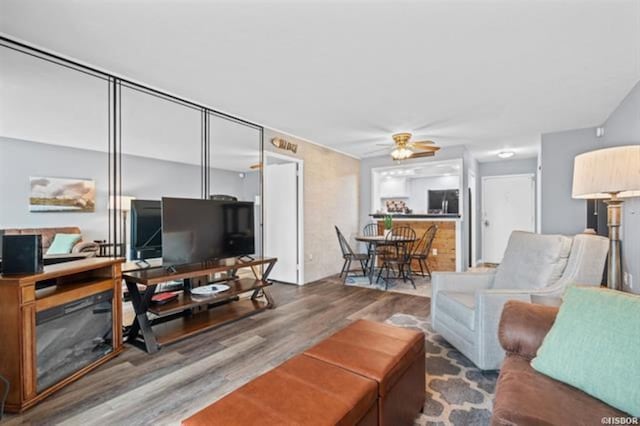 living room with hardwood / wood-style flooring and ceiling fan