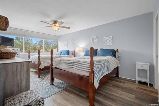 bedroom featuring ceiling fan and dark hardwood / wood-style floors