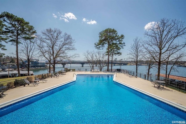 view of pool with a patio area and a water view