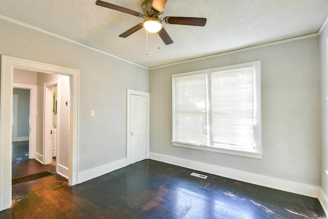 unfurnished room with dark hardwood / wood-style flooring, ceiling fan, ornamental molding, and a textured ceiling