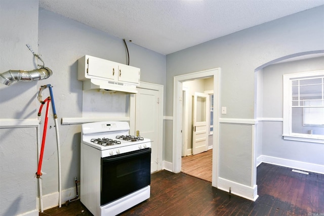 kitchen with white gas range, dark hardwood / wood-style floors, white cabinets, and a textured ceiling