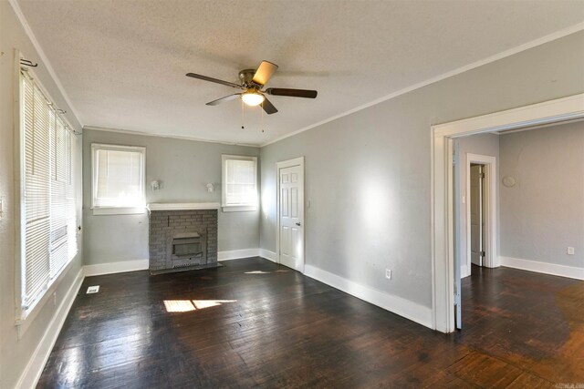 unfurnished living room featuring a brick fireplace, ceiling fan, hardwood / wood-style floors, and crown molding