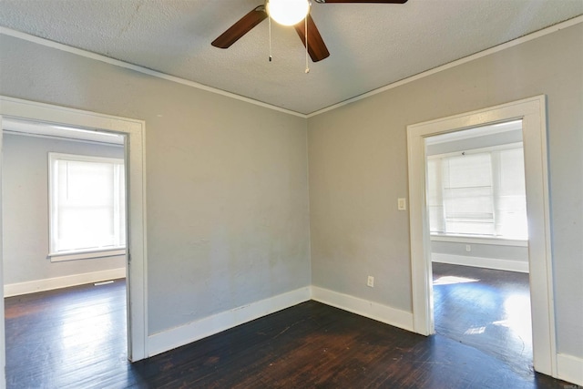 empty room featuring crown molding, ceiling fan, a textured ceiling, and dark hardwood / wood-style flooring