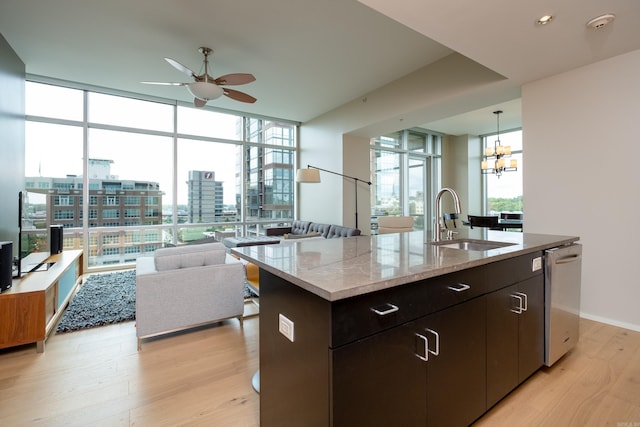 300 Third Unit 708, Little Rock, AR 72201 - kitchen featuring a sink, a ceiling fan, light wood-style floors, dishwasher, and floor to ceiling windows