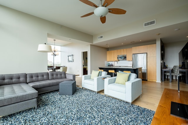 300 Third Unit 708, Little Rock, AR 72201 - living area with light wood-type flooring, ceiling fan, recessed lighting, and a chandelier