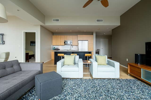 300 Third Unit 708, Little Rock, AR 72201 - living area featuring light wood finished floors, ceiling fan, and baseboards