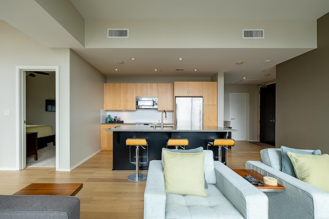 300 Third Unit 708, Little Rock, AR 72201 - living room featuring light wood-style flooring, recessed lighting, and baseboards