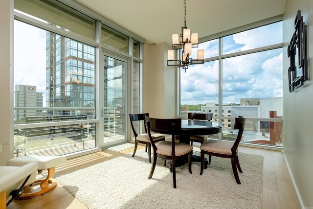 300 Third Unit 708, Little Rock, AR 72201 - dining room featuring expansive windows, plenty of natural light, a chandelier, wood finished floors, and a city view