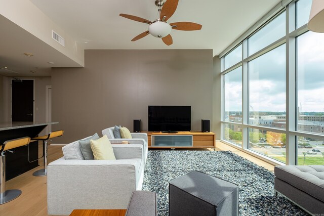 300 Third Unit 708, Little Rock, AR 72201 - living room with healthy amount of natural light, light wood-type flooring, ceiling fan, and expansive windows