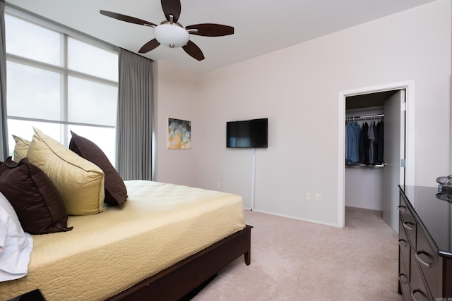 300 Third Unit 708, Little Rock, AR 72201 - bedroom featuring a spacious closet, light colored carpet, a closet, ceiling fan, and baseboards