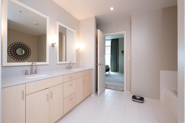 300 Third Unit 708, Little Rock, AR 72201 - bathroom with double vanity, a bath, baseboards, and tile patterned flooring