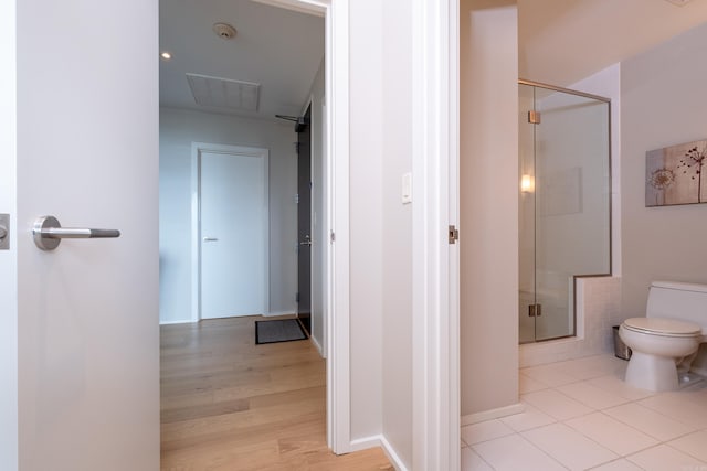 300 Third Unit 708, Little Rock, AR 72201 - bathroom with toilet, a shower stall, and wood finished floors