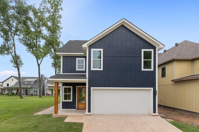 view of front of home with a garage and a front lawn