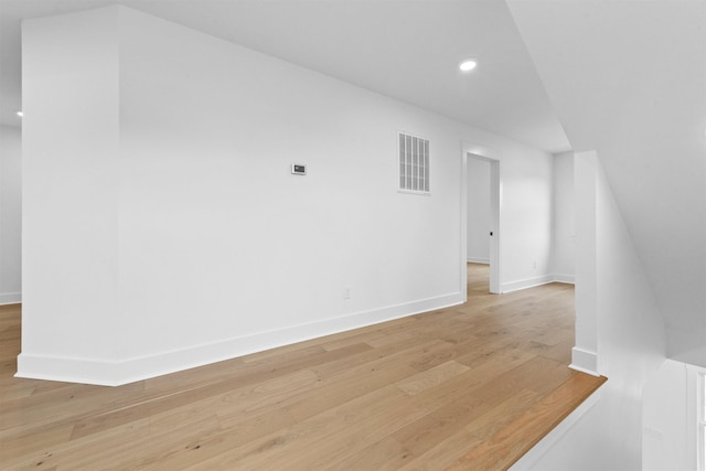 additional living space with light hardwood / wood-style flooring