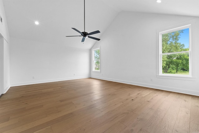 interior space with ceiling fan, wood-type flooring, and vaulted ceiling