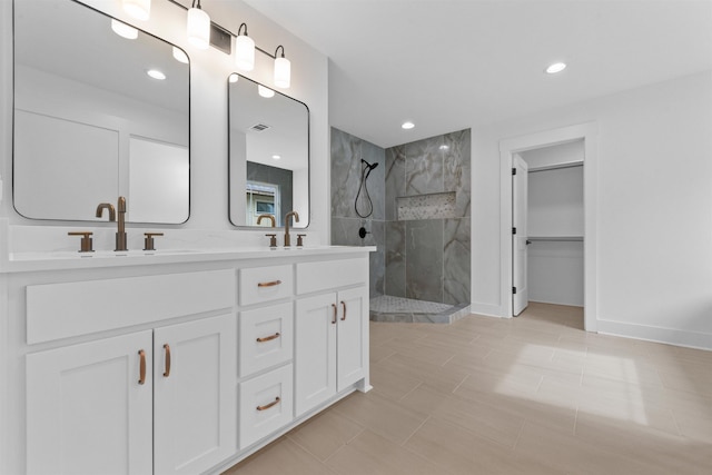 bathroom with vanity and a tile shower