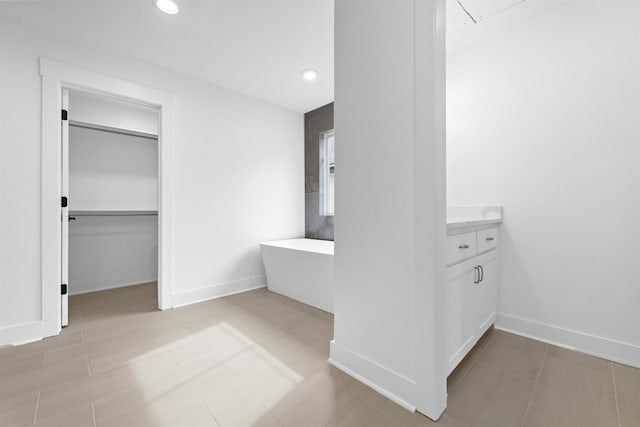 bathroom with vanity and a bath