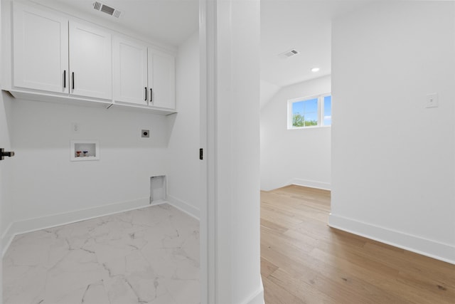 laundry area with cabinets, hookup for an electric dryer, and hookup for a washing machine