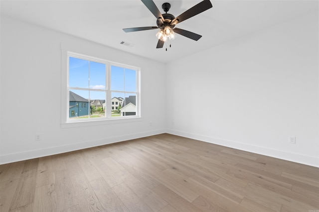 spare room with ceiling fan and light wood-type flooring