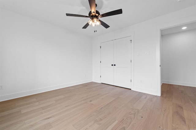 unfurnished bedroom featuring a closet, ceiling fan, and light hardwood / wood-style flooring