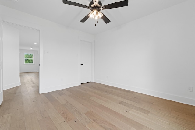 empty room with ceiling fan and light hardwood / wood-style floors