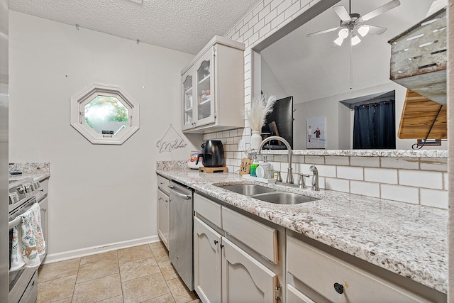 kitchen featuring stainless steel appliances, sink, decorative backsplash, and white cabinets