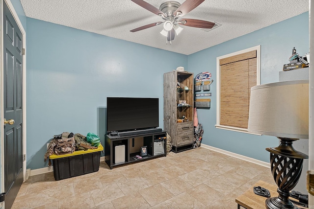 interior space featuring a textured ceiling and ceiling fan