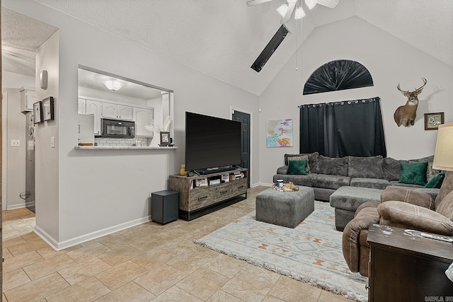 living room with a textured ceiling, high vaulted ceiling, and ceiling fan