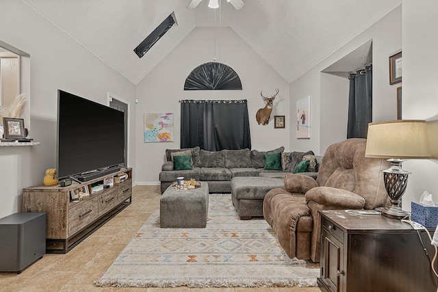 living room with a textured ceiling, high vaulted ceiling, and ceiling fan