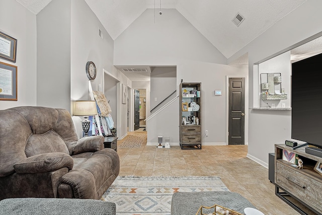 tiled living room with high vaulted ceiling