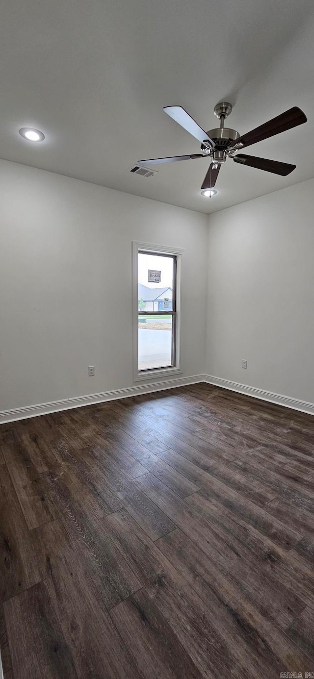 empty room featuring ceiling fan and dark hardwood / wood-style flooring