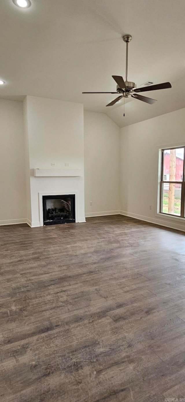 unfurnished living room featuring lofted ceiling, dark wood-type flooring, and ceiling fan