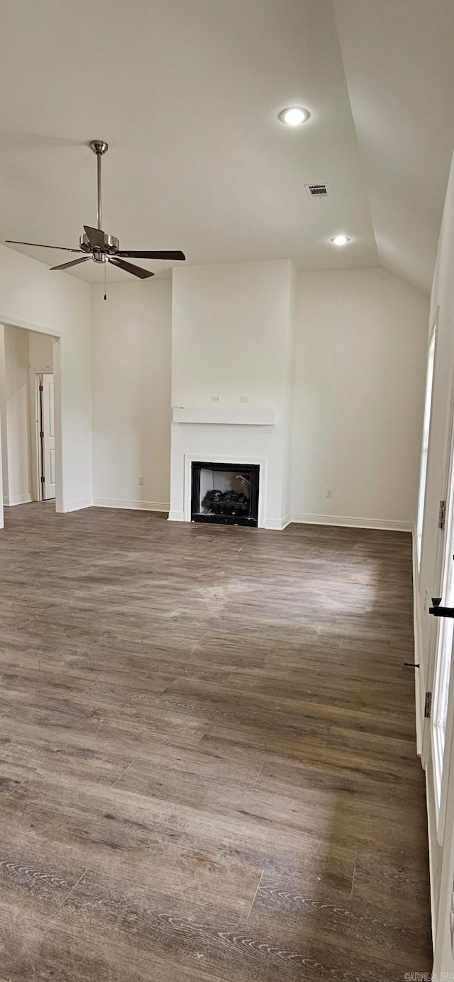 unfurnished living room with lofted ceiling, ceiling fan, and dark hardwood / wood-style flooring