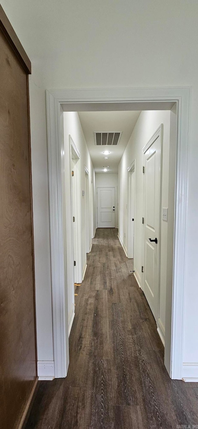 hall with dark hardwood / wood-style floors