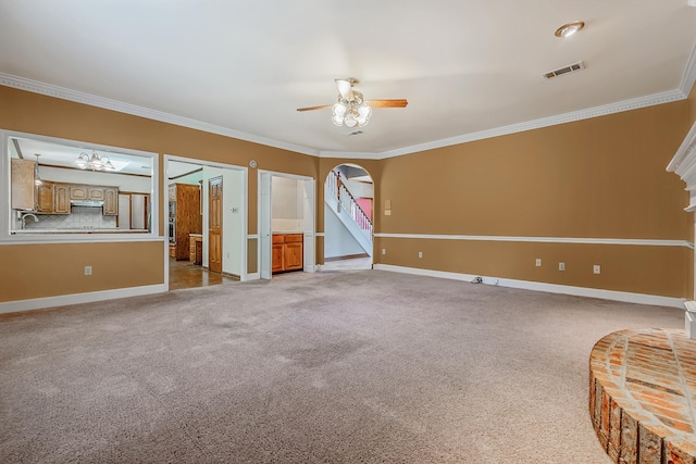 spare room featuring ceiling fan, ornamental molding, and light carpet