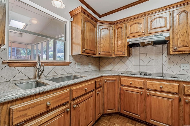 kitchen with sink, black electric stovetop, ornamental molding, light stone countertops, and parquet floors